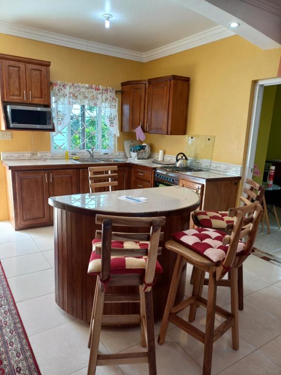 Kitchen island close-up with bar stools and wooden cabinets